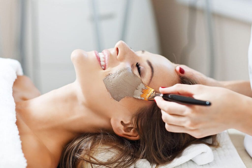 Woman with facial mask in beauty salon