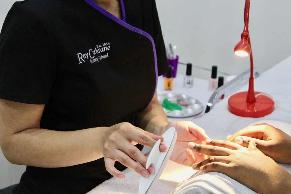 Student performing a Manicure