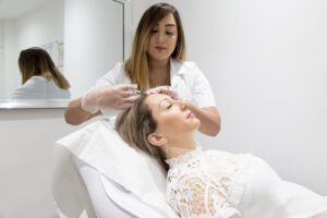 Sanna Mirza performing a treatment on a woman in a beauty therapy room