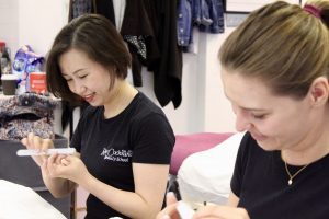 two beauticians nail filing in Ray Cochrane Beauty School
