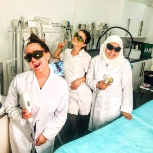 level 4 laser students smiling in a fun photo with tutor